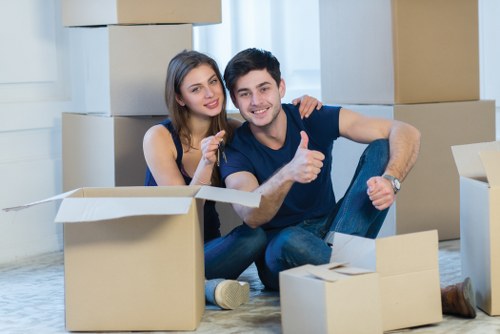 Professional movers carrying furniture in Lampton flat